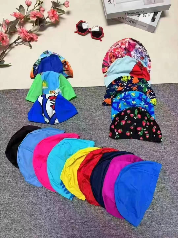 About 70000 Pieces Solid & Printed Swim Caps, 50000 Adult 20000 Kids - Image 1